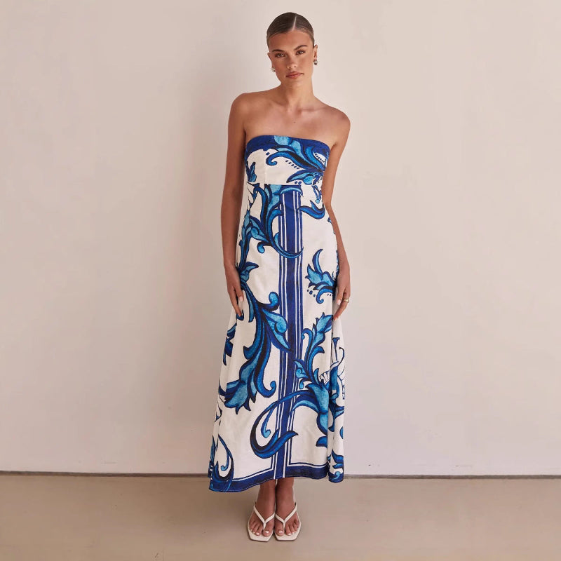 A model wearing a slim-fit, strapless, printed midi dress with a one-shoulder collar, suitable for casual wear.