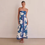 A model wearing a slim-fit, strapless, printed midi dress with a one-shoulder collar, suitable for casual wear.