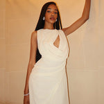 An elegant, sleeveless long dress with a high neck and pleated texture.
