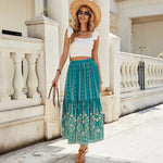 A woman wearing a vibrant, red, flared hem midi skirt with a high waist and pleated details.