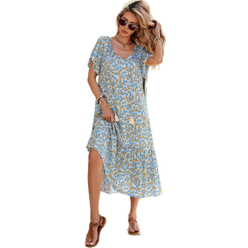 A floral, A-line midi dress with a V-neck and short sleeves, shown on a model.