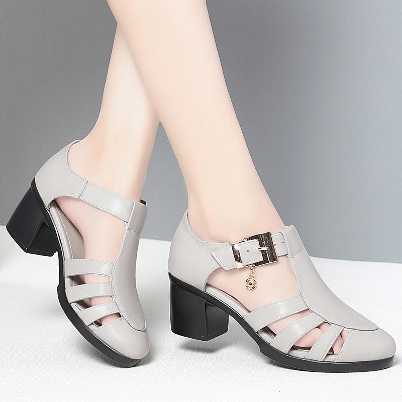 A pair of new style hollow sandals with a round toe and low heel, featuring a buckle closure and two-layer cowhide material.