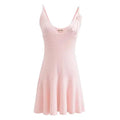 A sleeveless, V-neck, A-line mini dress in a criss-cross knitted pattern, adorned with floral appliques, available in pink and white, with a backless design.