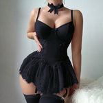 A close-up of a delicate black mesh and lace dress with small bow suspenders, highlighting the intricate lace patterns and sheer fabric.