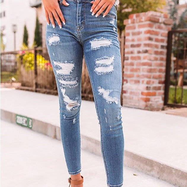 These high-waisted ripped elastic jeans combine edgy style with a comfortable, flexible fit for a bold, confident look.