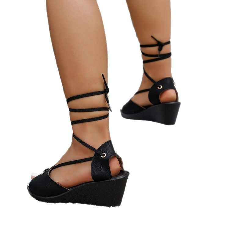 A pair of black plus size wedge sandals with a fish-mouth toe and leather upper, suitable for casual wear.