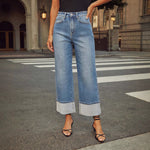 A pair of light blue, faded, straight leg high-waisted jeans for women.