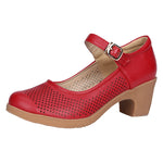 A pair of hollow sandals with a buckle closure, round toe, and low heel, showcasing the casual style and comfortable design.