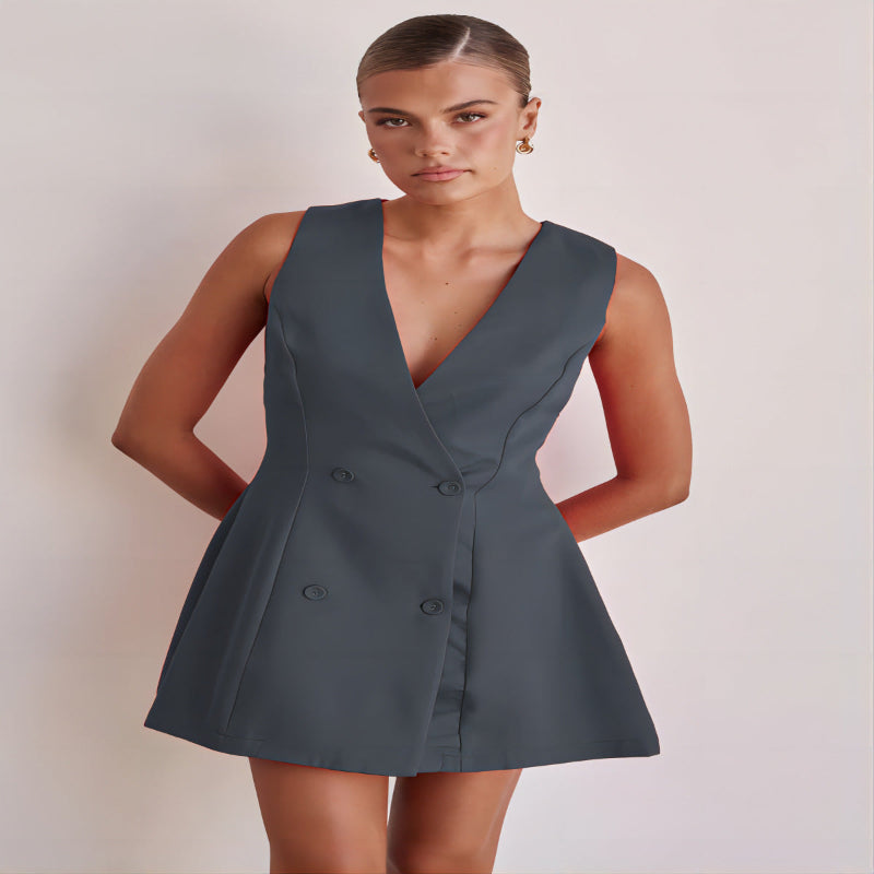 A model wearing a solid color sleeveless short V-neck dress.