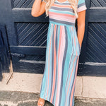 Model wearing loose fit striped high waist dress with short sleeves