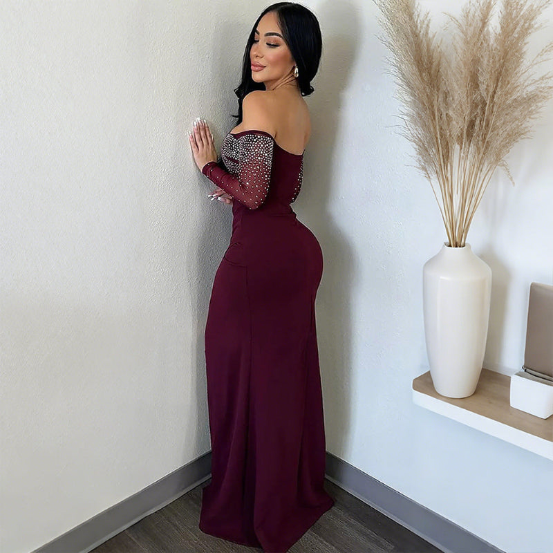 A red strapless midi dress with a high slit and rhinestone embellishments, designed for elegant office wear.
