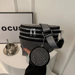 A medium-sized black crossbody bag made of PU material, adorned with metallic studs and featuring an adjustable strap.
