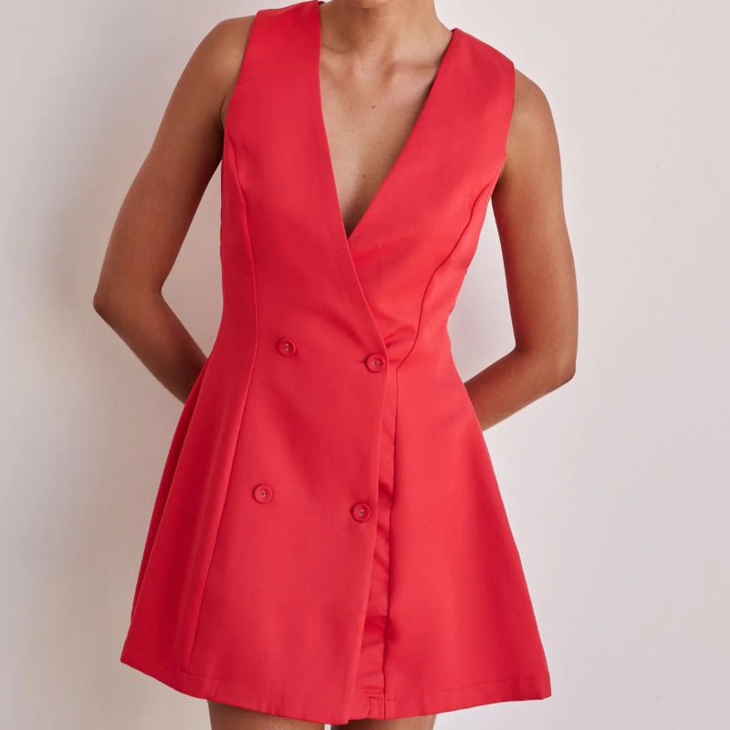 A model wearing a solid color sleeveless short V-neck dress.