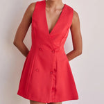 A model wearing a solid color sleeveless short V-neck dress.