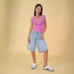 A pair of dark blue, mid-length, vintage-style denim shorts with a distressed finish. The shorts are laid flat, showcasing the straight-leg cut and medium-rise waist.