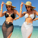 A model wearing a three-piece swimsuit set, which includes a bikini top, bikini bottoms, and a long mesh cover-up dress. The swimsuit is available in various colors and is shown in a beach setting.