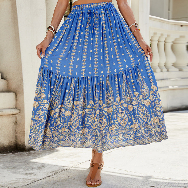 A woman wearing a vibrant, red, flared hem midi skirt with a high waist and pleated details.