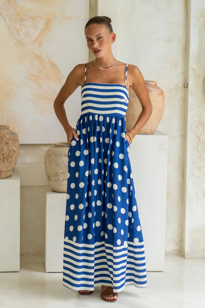 A sleeveless, high-waisted, midi-length dress with a printed pattern and a one-shoulder, backless design, photographed on a white background.