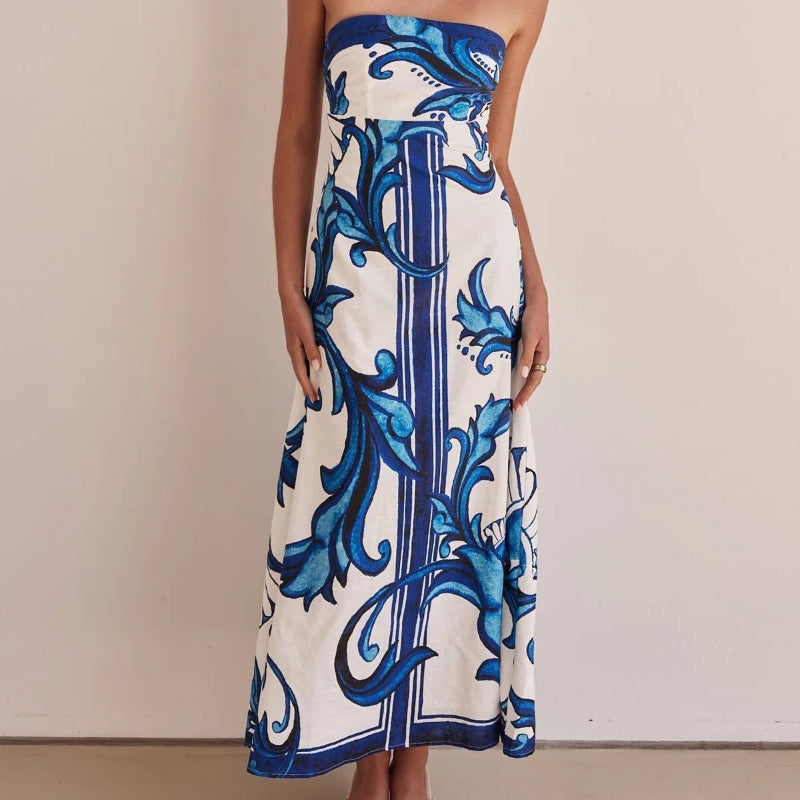 A model wearing a slim-fit, strapless, printed midi dress with a one-shoulder collar, suitable for casual wear.