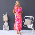 Model wearing a light blue split sleeveless printed midi dress with elegant flair in outdoor setting