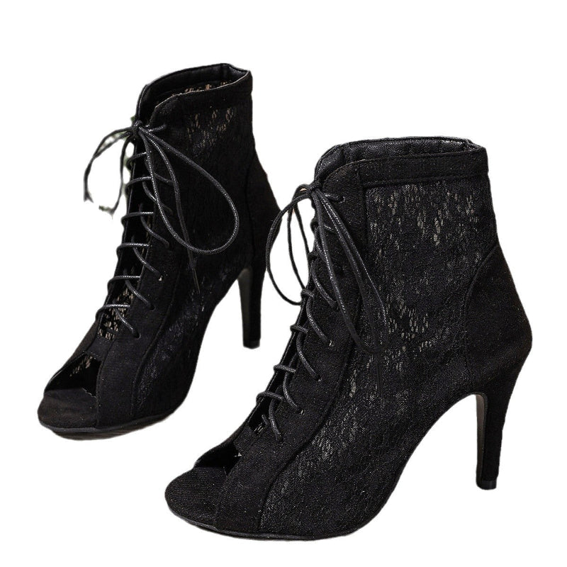 A pair of black, ultra-high, slim high-heeled mesh sandal boots with a fish-mouth toe.