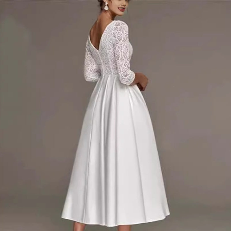 White lace dress with long sleeves on a plain background