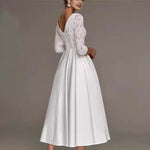White lace dress with long sleeves on a plain background