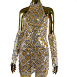 Gold and silver sequin dress on a mannequin against a white background