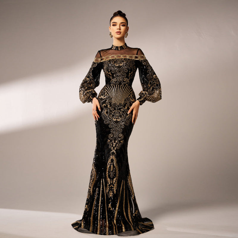 Woman wearing a black and gold evening gown with intricate patterns on a neutral background