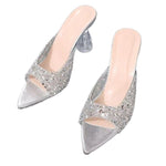 Pair of silver glitter high heels on a white background