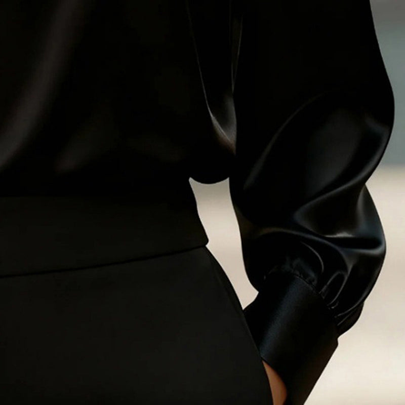 Close-up of a person wearing a black outfit with a blurred background
